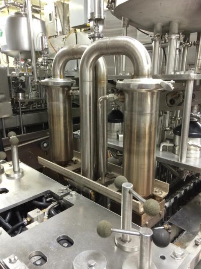 Stainless steel pipes and levers in a food processing machine