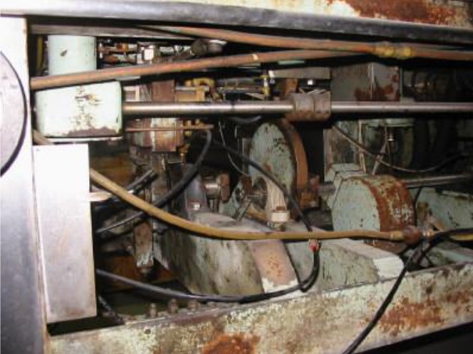 Close-up of a complex assembly of machinery showing rusted components