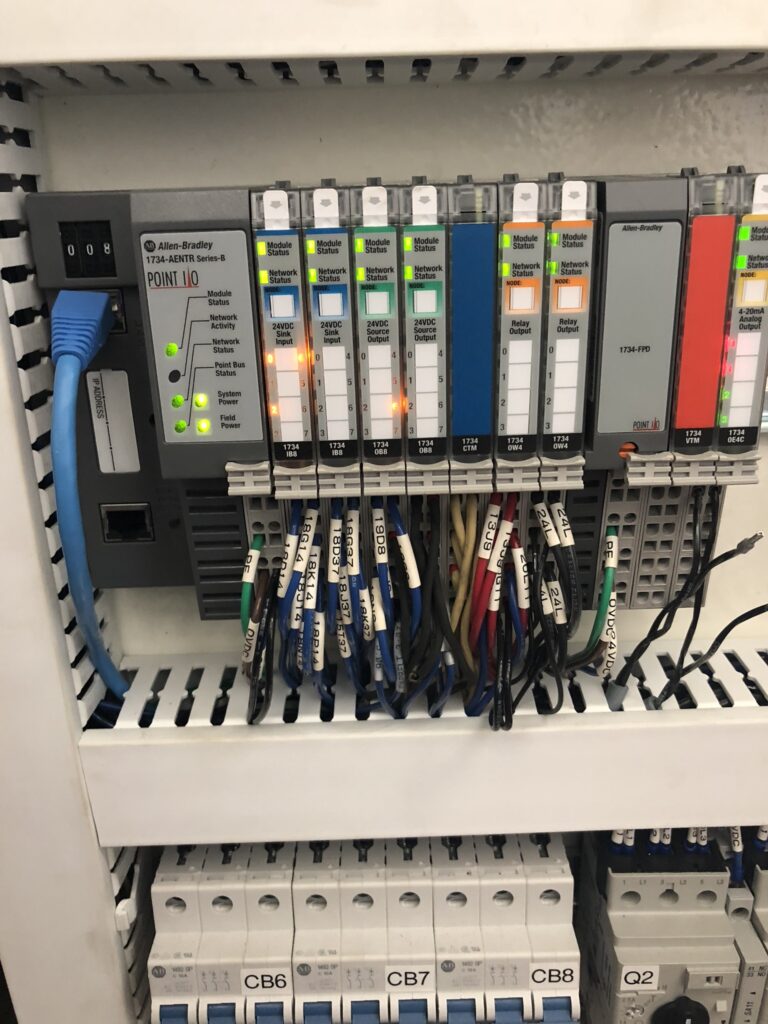 Allen-Bradley POINT I/O system with multiple modules and indicator lights mounted on a control panel